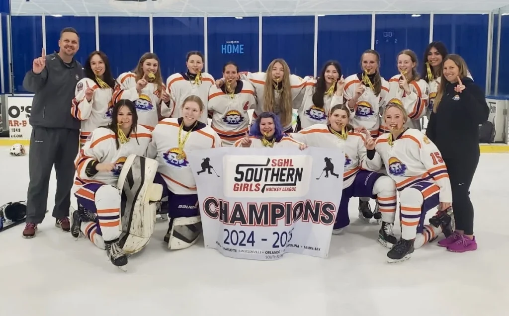 The CFHC Lady Bears 19U team and coaches posing on the ice with an SGHL 2024-25 Champions banner.